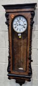 A 20TH CENTURY VIENNA WALL CLOCK, the arched glass door enclosing a 7.5 inch brass and enamel