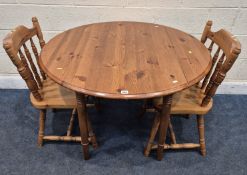 A MODERN PINE DROP LEAF TABLE, raised on turned legs, diameter 107cm x width 69cm x height 75cm,
