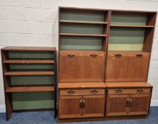 G PLAN, A MID-CENTURY TEAK WALL UNIT, fitted with an arrangement of shelves, two fall front doors,
