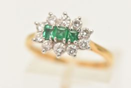 AN 18CT YELLOW GOLD EMERALD AND DIAMOND CLUSTER RING, three square cut emeralds, set with a surround
