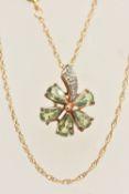 A 9CT GOLD GEM SET PENDANT NECKLACE, flower shape pendant set with light green pear cut stones and