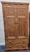 A MODERN PINE DOUBLE DOOR WARDROBE, atop a base with two drawers, width 106cm x depth 52cm x