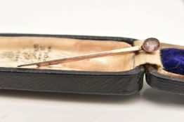 AN EARLY 20TH CENTURY YELLOW METAL STICK PIN, set with an oval cut amethyst, approximate length