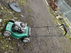 A QUALCAST SELF PROPELLED PETROL LAWN MOWER with collection bag (engine pulls freely but hasn't been