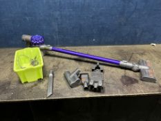 A DYSON V6 ANIMAL CORDLESS VACUUM CLEANER with wall bracket, charger and three accessories (PAT pass