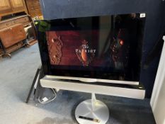 A BANG & OLUFSEN BEOVISION 7-32 TV with 32in screen, motorised stand, soundbar, manual and remote (
