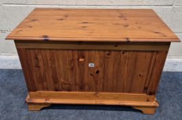 A MODERN PINE BLANKET CHEST, with a hinged lid, raised on bracket feet, width 92cm x depth 52cm x