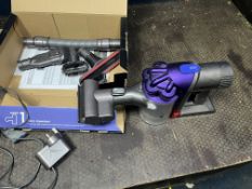A DYSON DC31 ANIMAL HANDHELD VACUUM CLEANER with box, charger and accessories, along with a tower