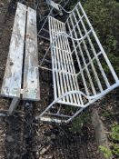 AN EARLY 20th CENTURY WROUGHT IRON STRAPWORK GARDEN BENCH with metal slatted seat and back, 185cm
