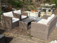 A FAUX RATTAN FOUR-PIECE GARDEN SET, comprising a two seater bench, two armchairs and a coffee table