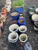 TWELVE BLUE GLAZED PLANT POTS, of various shapes and sizes, the largest being 52cm high