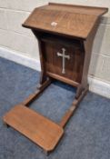 A 20TH CENTURY OAK PRIE DIEU, with an angled book rest, a pierced cross decoration, and a folding