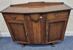 AN EARLY 20TH CENTURY OAK SIDEBOARD, fitted with two drawers over two cupboard doors, width 122cm