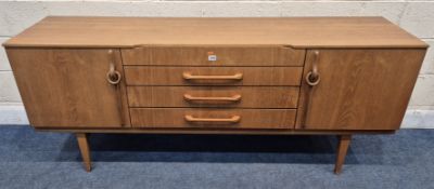 BEAUTILITY, A MID-CENTURY TEAK SIDEBOARD, fitted with two cupboard doors, flanking four drawers, the