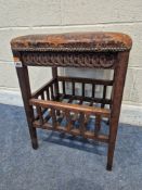 AN EARLY 20TH CENTURY OAK STOOL, with leather upholstery, pokerwork and repeating carved patterns,