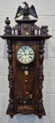 A 20TH CENTURY MAHOGANY VIENNA WALL CLOCK, with an Eagle crest, the arched glass door enclosing an 8