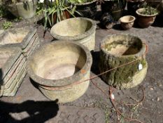 THREE CONCRETE ROUND PLANTERS, including a hollow tree stump design, 29cm high (3)