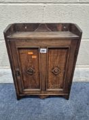 AN EARLY 20TH CENTURY OAK HANGING CUPBOARD, the single door enclosing a fitted interior, width