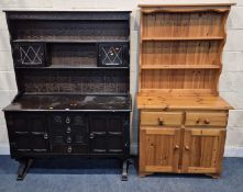 A DARK OAK DRESSER, with two lead glazed doors, atop a base with four drawers, flanked by two