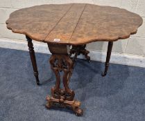 A VICTORIAN BURR WALNUT SUTHERLAND TABLE, raised on scrolled legs with brass castors, united by a