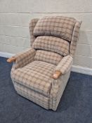 A BEIGE TARTAN EFFECT UPHOLSTERED ARMCHAIR, raised on castors, width 80cm x depth 90cm x height