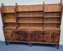 A LARGE PINE ECCLESIASTICAL WALL UNIT, with an arrangement of shelves and six cupboard doors, length