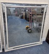 A LARGE FRENCH STYLE WHITE PAINTED BEVELLED EDGE WALL MIRROR, with metal foliate decoration to the