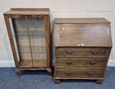 AN EARLY 20TH CENTURY OAK BUREAU, the fall front door enclosing a fitted interior, over three