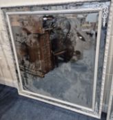 A LARGE FRENCH STYLE WHITE PAINTED BEVELLED EDGE WALL MIRROR, with metal foliate decoration to the
