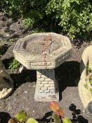 A CONCRETE BIRD BATH, with brickwork effect base and an octagonal top, 63cm high