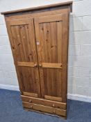 A MODERN PINE DOUBLE DOOR WARDROBE, with two drawers, width 95cm x depth 55cm x height 183cm,