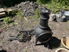 A SMALL CAST IRON CHIMINEA, 90cm high, and a pair of cast iron bench ends (3)