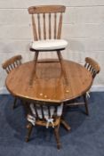A MODERN PINE CIRCULAR KITCHEN TABLE, raised on a single pedestal with four legs, diameter 115cm x