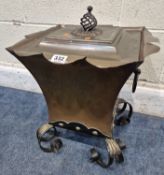 AN ARTS AND CRAFTS COPPER COAL SCUTTLE, with a removable lid, twin handles, raised on scrolled legs,