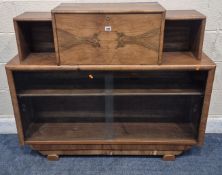 AN ART DECO WALNUT CABINET, the fall front door enclosing a fitted interior, over double glass