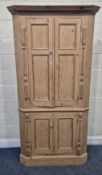 A LARGE PINE CORNER CUPBOARD, fitted with four cupboard doors, width 102cm x depth 44cm x height