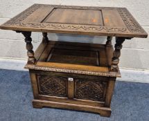 A 20TH CENTURY OAK MONKS BENCH, with a tilting surface/backrest, raised on turned supports, a hinged