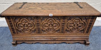 A 20TH CENTURY OAK BLANKET CHEST, with iron hinged, repeating carved details, width 102cm x depth