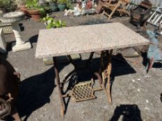 A CAST IRON SINGER SEWING MACHINE BASE, with a pink granite top, width 84cm depth 50cm, height