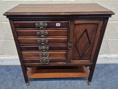 AN EDWARDIAN MAHOGANY MUSIC CABINET, with six fall front drawers, beside a single cupboard door,
