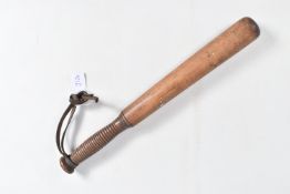 A TURNED WOODEN TRUNCHEON OR BILLY CLUB, this has a dark wood turned grip with a leather wrist strap