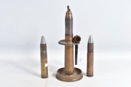 A LARGE TRENCH ART TABLE LIGHTER AND TWO INERT LARGE BULLETS, the lighter is set into a trench art