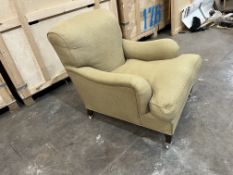 A HOWARD AND SONS STYLE ARMCHAIR, on square turned legs, and chrome casters, width 80cm x depth