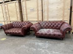 A PAIR OF RED LEATHER CHESTERFIELD SOFAS, with out swept armrests, on turned feet, length 205cm x