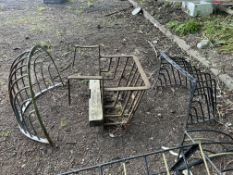 THREE VINTAGE WROUGHT IRON HAY RACKS, one fence hanging, 63cm wide, another wall hanging rack half
