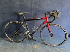 A CARRERA VANQUISH ROAD PRO RACING BIKE with a lightweight 21in aluminium frame, 18 speed Shimano