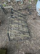 TWO WALL MOUNTED WROUGHT IRON HAY RACKS, one angular in design, 114cm wide, the other curved and