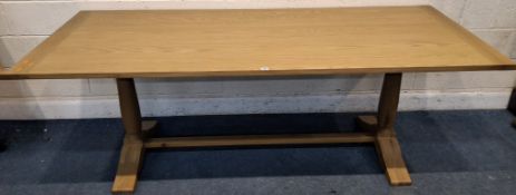 A LARGE RECTANGULAR OAK REFECTORY DINING TABLE, raised on twin supports, united by a stretcher,
