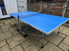 A CORNILLEAU FOLDING TABLE TENNIS TABLE, with built in net and cover, 274cm long