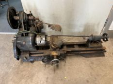 A VINTAGE UNBRANDED ENGINEERING LATHE, with total length of 114cm, motor, switch, a 4 jaw chuck.